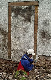 paddy removing harling near old south wall doorway